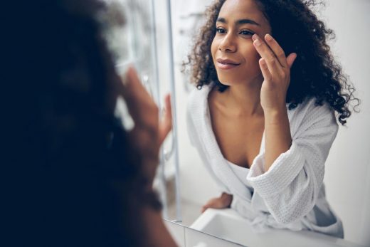 fermme regardant ses yeux dans le miroir