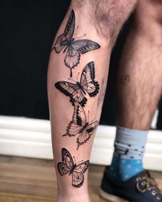 Tatouage De 4 Papillons Noir Et Gris Sur La Jambe 