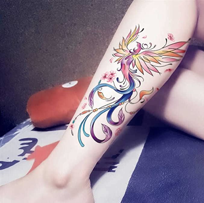 Tatouage Phœnix Multicolore Et Motifs Floraux Sur La Jambe