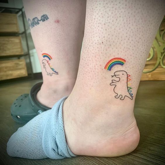 Tatouage Dinosaure Et Arc En Ciel Sur Le Pied