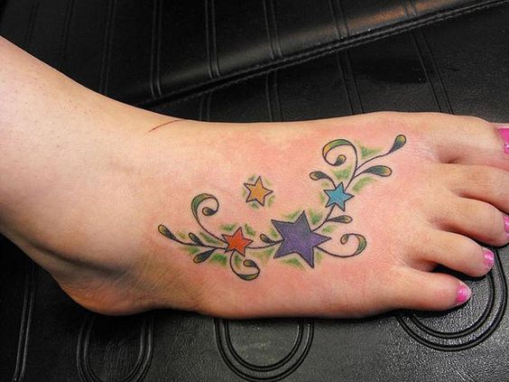 Tatouage étoiles Colorées Et Plante Verte Sur Le Pied