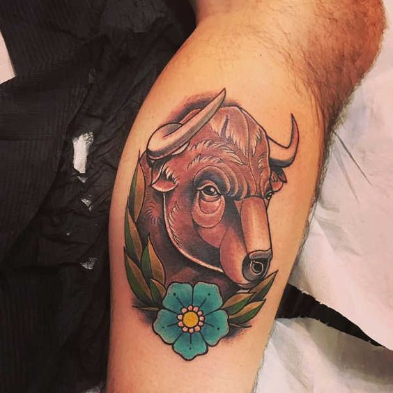 Tatouage Taureau Brun Et Fleur Bleue Sur La Jambe