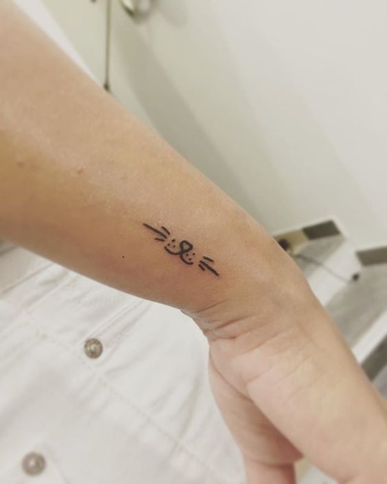 Tatouage Tête De Chat Minimaliste Sur Le Poignet
