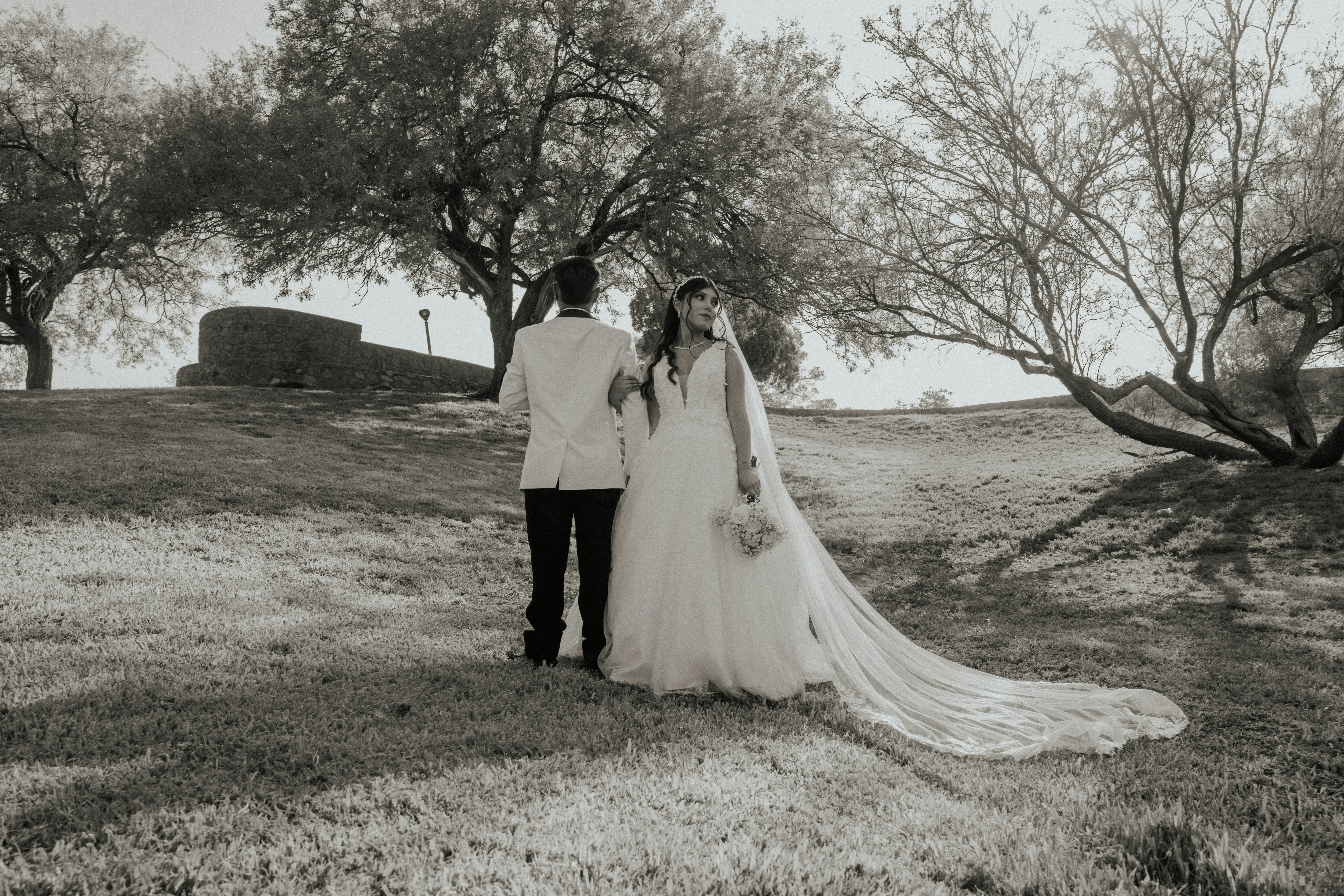 Bride And Groom Walking Away In A Park