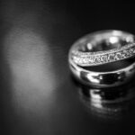 Two Wedding Rings On A Dark Surface
