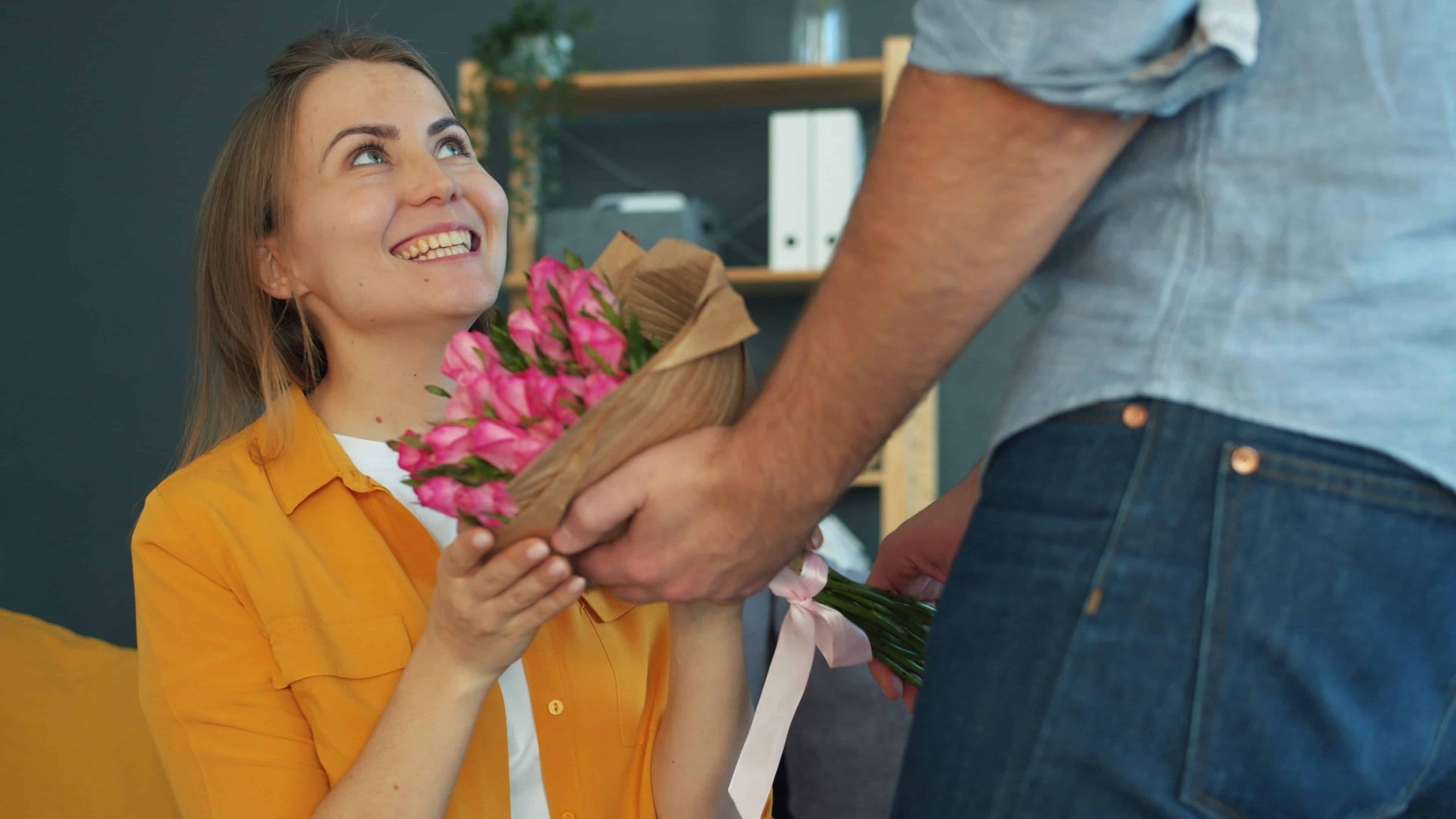 Man Gives Woman A Bouquet Of Pink Roses